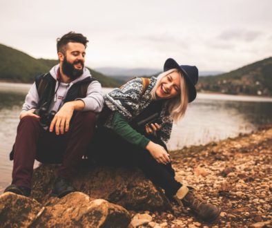 Young smiling couple enjoying nature and their hiking together